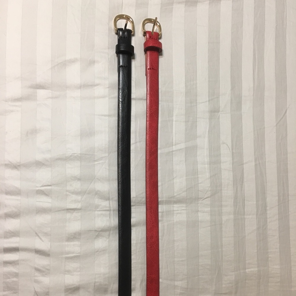 Bundle of red and black faux leather thin belts